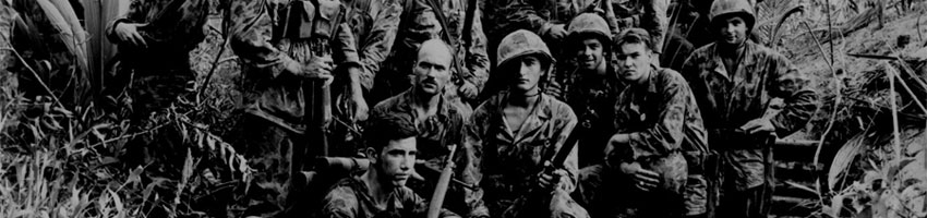 They are U.S. Marine Raiders gathered in front of a Jap dugout on Cape Totkina on Bougainville