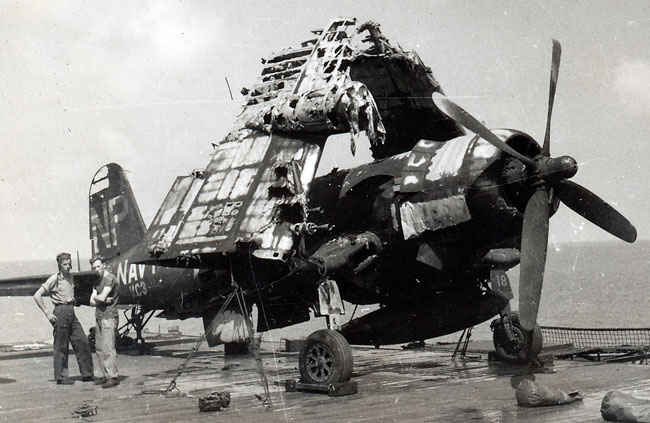 Corsair after the Boxer fire on desk. Many planes were so badly damaged they were pushed over desk.