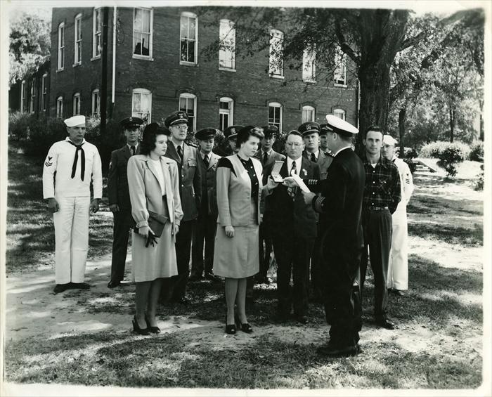 Presentation of the Silver Star Medal to his wife 5 October 1946 Brown Hall, Alabama Polytechnic Institute,  Auburn, AL.  His brother Earl in the plaid shirt.