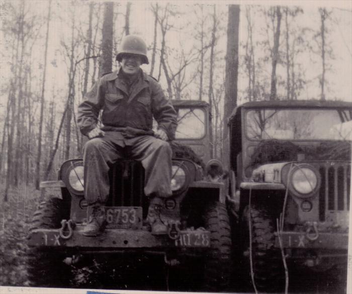 Unidentified soldier on maneuver.  Dad's 1st ID HQ CO, 1951 license plate.
