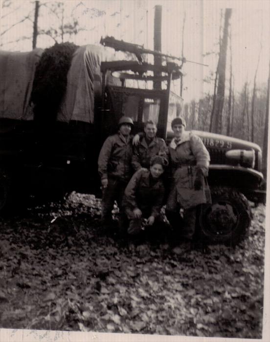 Unknown, left, "English," (Cpl. Harry J. English), John Tubinis, (Dad), Cpl. Edward Iusiak, stooped.