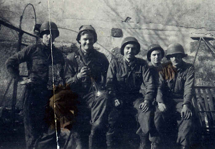 Far left top row is my grandfather and to the right of him is Parker. Shortly after this picture was taken in July, 1946 a plane flew over and dropped a bomb that landed 40 feet away. My grandfather said he moved pretty quickly during that episode. Notice that date of July, 1946 the war had ended in Germany by that time, something does not seem right. Germany surrendered on May 8th.