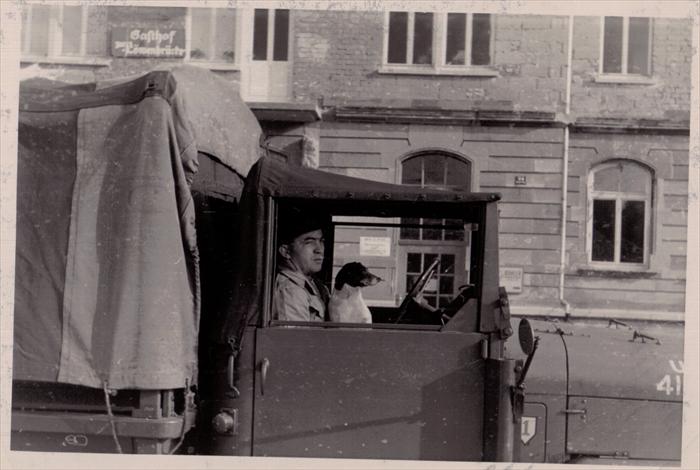 1st Infantry Division HQ CO soldier with mascot taken near the Lion Bridge in Wurzburg, 1952-1953.