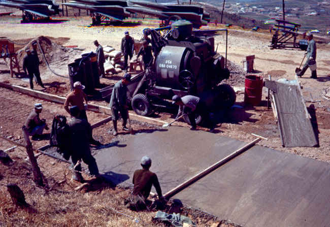 Korean peasants pouring concrete 1973-1974 at B Battery repairing a mudslide that happened the previous year..