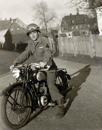 Wolke Staff Sergeant Stanley Flisak on the motorcycle.