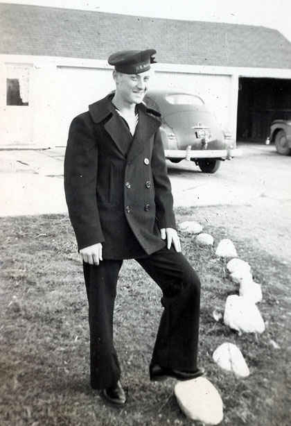 Gene Buettner with his Navy pea coat in Delphos, Ohio visiting his family. When Gene was about to be discharged someone had stole his pea coat, most likely to be sold on the black market for money by another sailor.