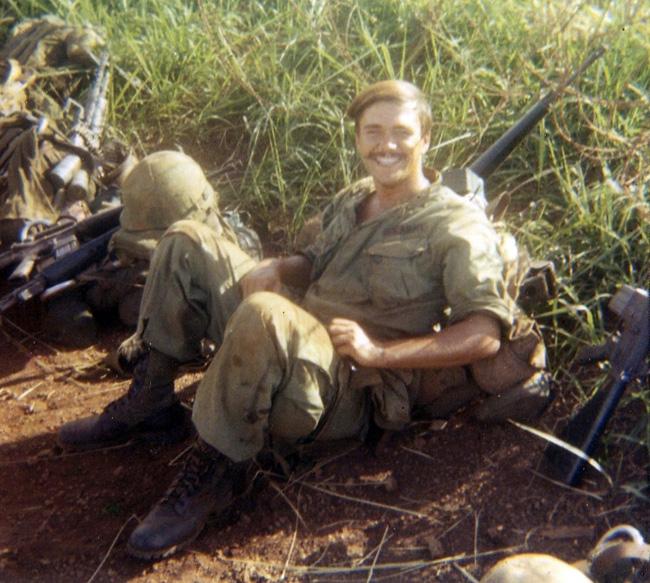 Eldon resting with his M-16 in Vietnam.