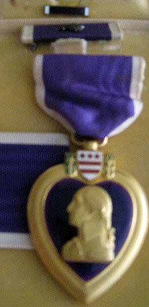 James LeMaster's Purple Heart earned while in the Pacific War in World War II. James was awarded the medal two times, once for being with shrapnel from a mortar in North Luzon, Philippines. He was also hit in Southern Luzon by a sniper bullet that exploded his grenade on his belt. The grenade hit ended James' military career.