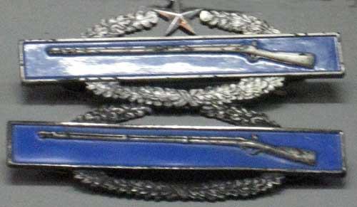 Combat Infantry Badge. Notice one has a star in the wreath, this stands means that Carl was awarded the Combat Infantry Badge because he saw direct fire in two wars. This is very rare.