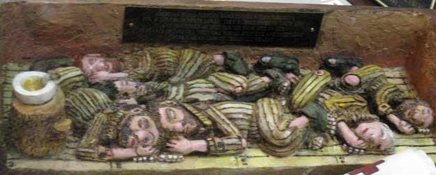 Carving of POWs sleeping in North Korean camps. This was carved by Carl Cossin from one piece of wood. Notice there are no blankets, no beds, no pillows, or any other semblance of humane treatment.