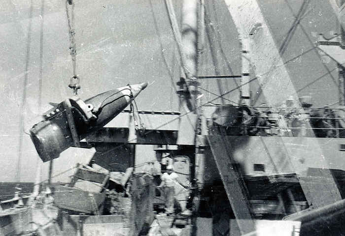 Loading a 16-inch shell for a battleship. Look at the man standing to the right and compare him to the size of this shell. Imagine one of these being fired from a gun, wow.