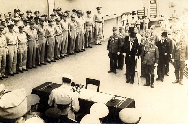 September 2, 1945 Emperor Hirohito signing the document for Japan to formally surrender on the battleship USS Missouri, anchored in Tokyo Bay.