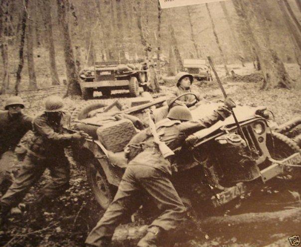 Taken from the Rainbow Division History Book, he is farthest to left at the back of the jeep