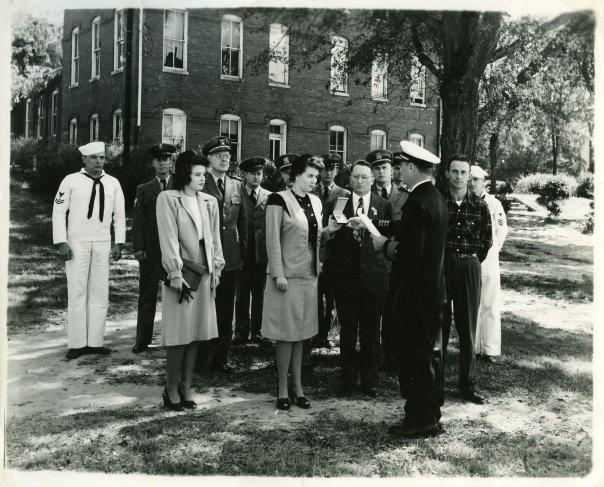 He is in the plaid shirt, at the presentation of the Silver Star Medal posthumously to his brother, Phm2c Kenneth Webb