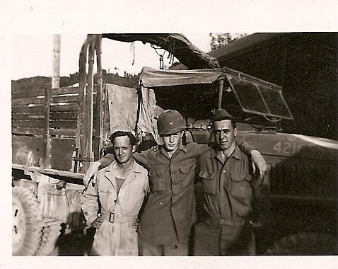 Carlos was sometimes assigned as a truck driver. This may be his truck, with Carlos in center.