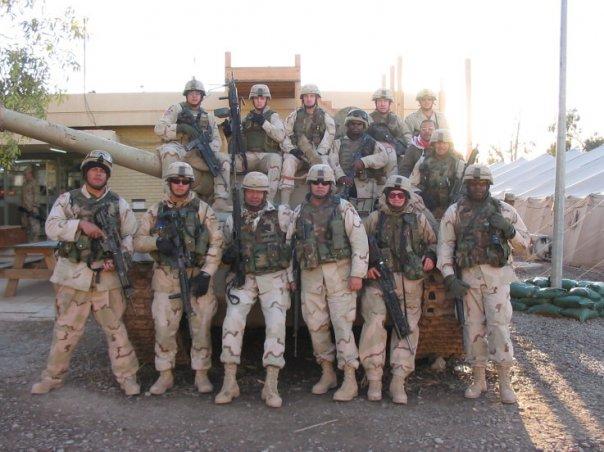 Nearly the entire EECP crew stands for a group photo on a former Iraqi Army (Russian-made) T-55 Tank.  Taken summer of 2004.