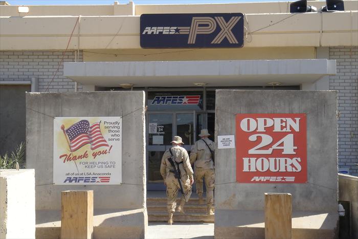 Closeup of Main Post Exchange (PX), notice the large concrete Jersey barriers that are directly in front of the main entrance.  These were erected after a large 122mm mortar hit the front of the PX in June 2004, killing one soldier and wounded dozen or more.