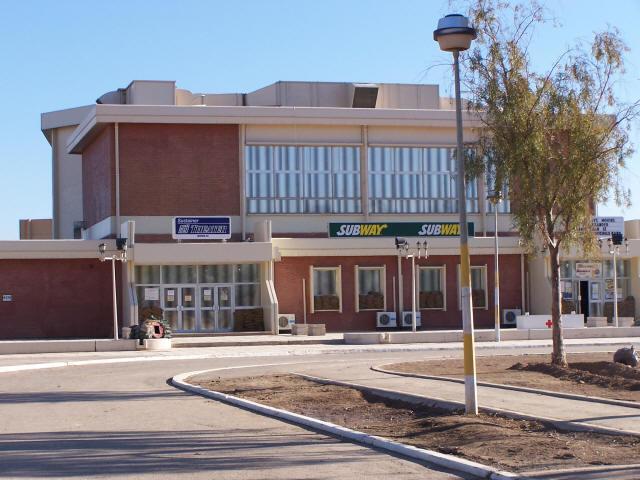 This is 'Sustainer Theater,' which was refurbished by 3rd COSCOM.  It showed nightly movies and was free to servicemembers and government contract civilians.  They showed first-run movies and were only behind about two weeks.  Inside it was air conditioned and had a small concessions stand.  It was enjoyable, except when the base was attacked by rockets or mortars.  Then we had to put our full 'battle rattle' on and wait to be given the 'All Clear' signal.  Good times.